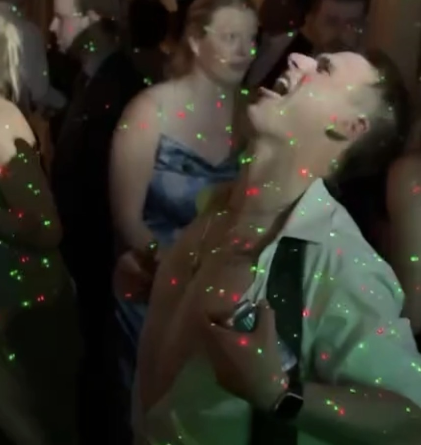 Guests dancing under laser lights at the Vassa Wedding